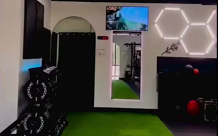 The open turf training area under the hexagon lights at The Gym TX